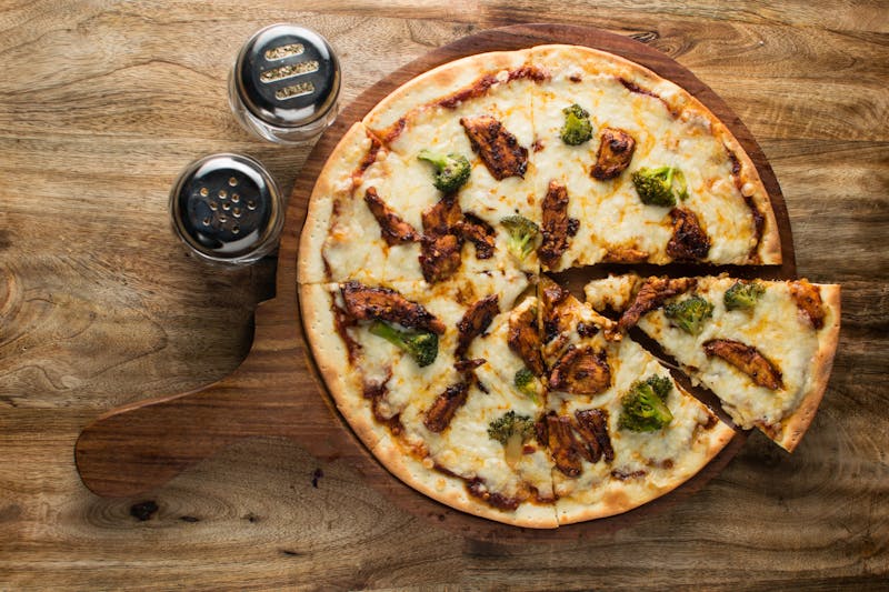 Meat lovers pizza loaded with sausage and ham on thin crust