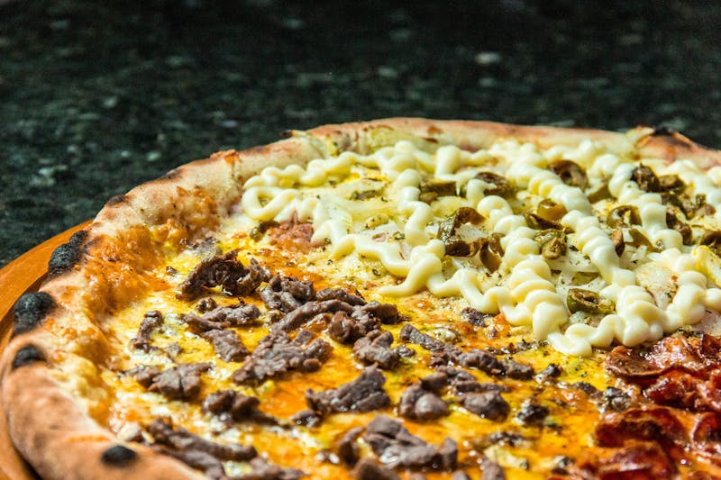 BBQ chicken pizza with smoky sauce and onions on thin crust